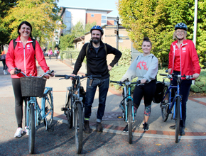 university staff pose on bikes for photo